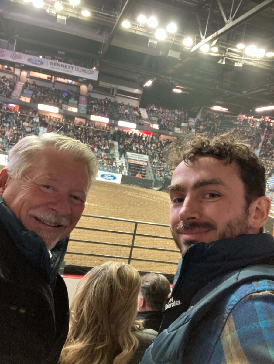 CPO Brock Moir, and CEO Rob Saik smiling while watching the Agribition Rodeo.